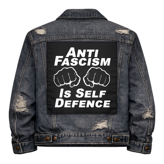 Black fabric back patch sew onto a denim jacket with the design "Self Defence"