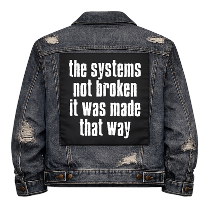 Black fabric back patch sew onto a denim jacket with the design "System Made Broken"