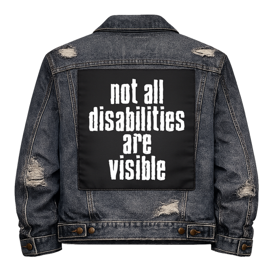 Black fabric back patch sew onto a denim jacket with the design "Not All Disabilities"