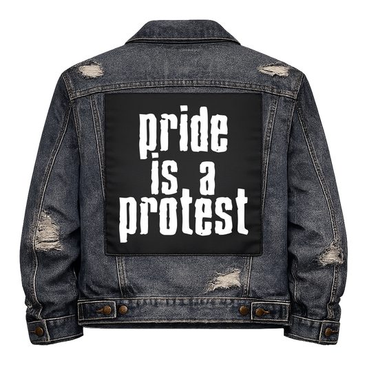 Black fabric back patch sew onto a denim jacket with the design "Pride is a Protest"