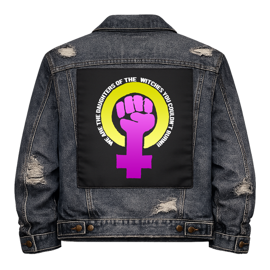 Daughters of Witches Full Colour Back Patch shown on the back of a distressed denim jacket: purple raised fist in a Venus symbol inside a yellow ring, with the slogan curved around it, reading "WE ARE THE DAUGHTERS OF THE WITCHES YOU COULDN'T BURN!"