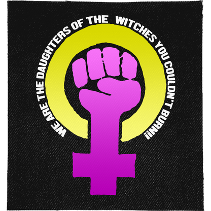 Daughters of Witches Full Colour Patch: purple raised fist in a Venus symbol inside a yellow ring, with the slogan curved around it, reading "WE ARE THE DAUGHTERS OF THE WITCHES YOU COULDN'T BURN!"