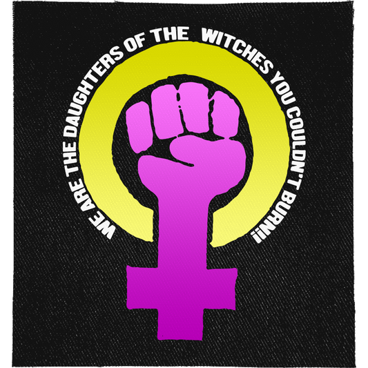 Daughters of Witches Full Colour Patch: purple raised fist in a Venus symbol inside a yellow ring, with the slogan curved around it, reading "WE ARE THE DAUGHTERS OF THE WITCHES YOU COULDN'T BURN!"
