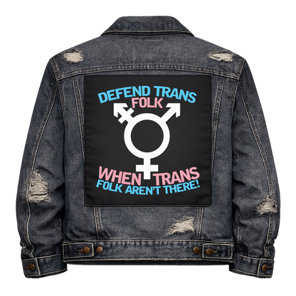 Defend Trans Folk Full Colour Back Patch shown on the back of a distressed denim jacket: trans symbol between lines of trans flag coloured lettering, reading "DEFEND TRANS FOLK WHEN TRANS FOLK AREN'T THERE!"