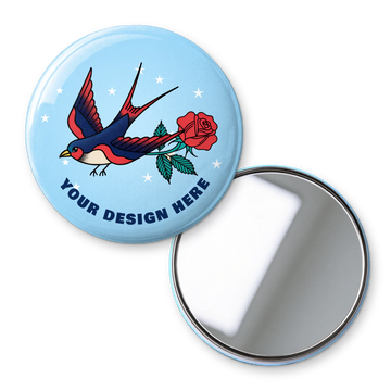 One-off custom pocket mirror printed with a tattoo-style swallow and rose on sky blue, shown with the mirror side