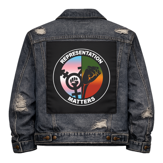 Representation Matters Full Colour Back Patch shown on the back of a distressed denim jacket: roundel split between a trans symbol on trans flag colours and a raised fist, reading "REPRESENTATION MATTERS"